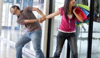 Man keeping a woman from entering a store